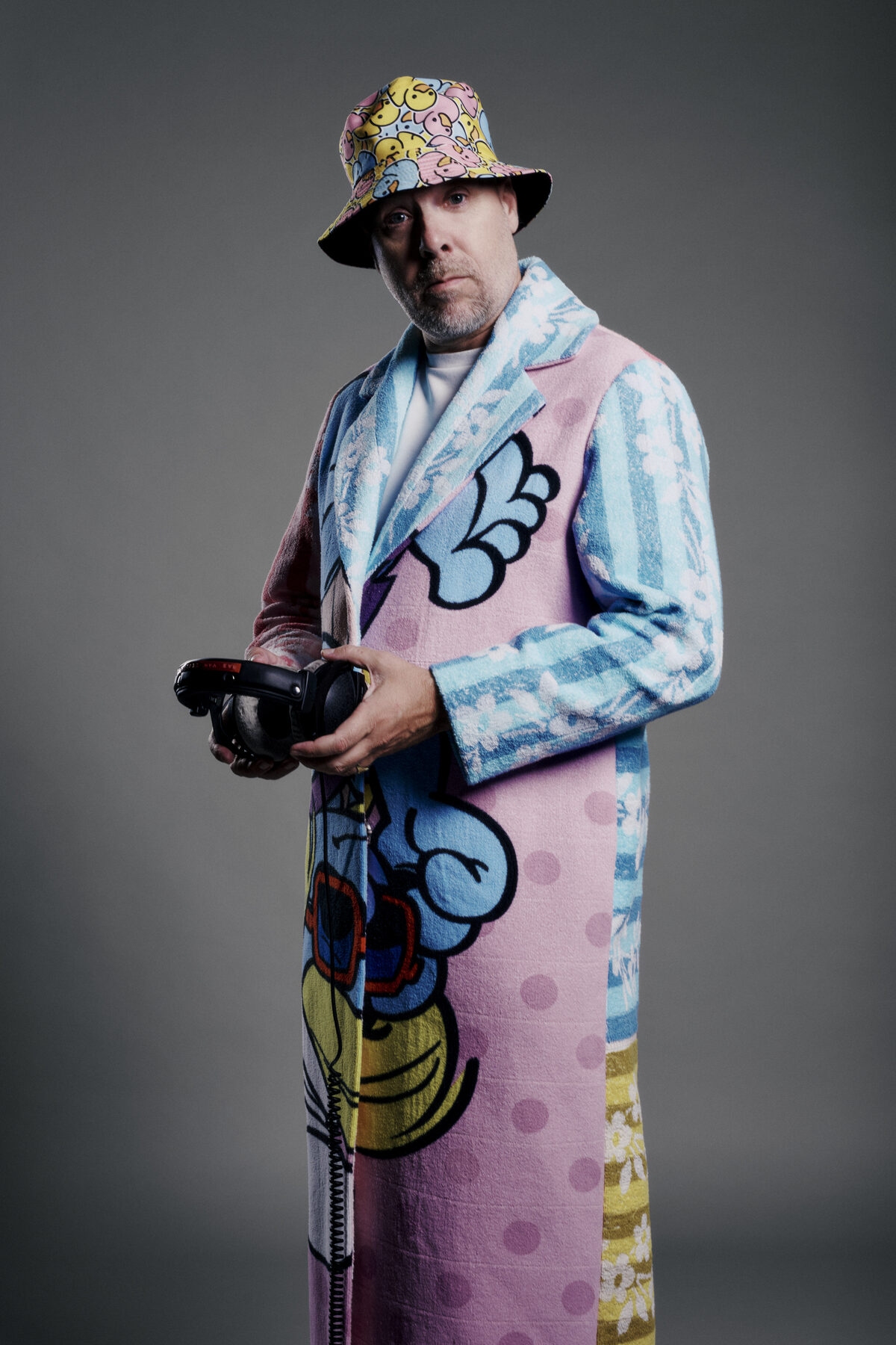Sebastien Bruce in a long colourful coat with headphones