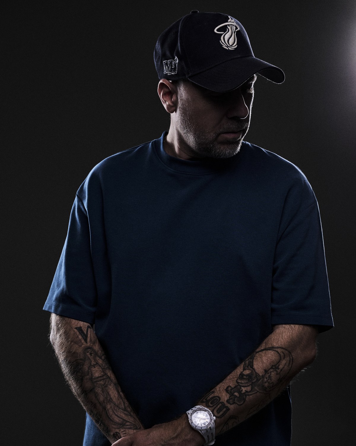Sebastien Bruce in a dark t-shirt and black cap